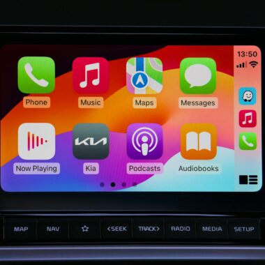 Close-up of a car's modern touchscreen display showcasing various app icons for enhanced in-car connectivity.