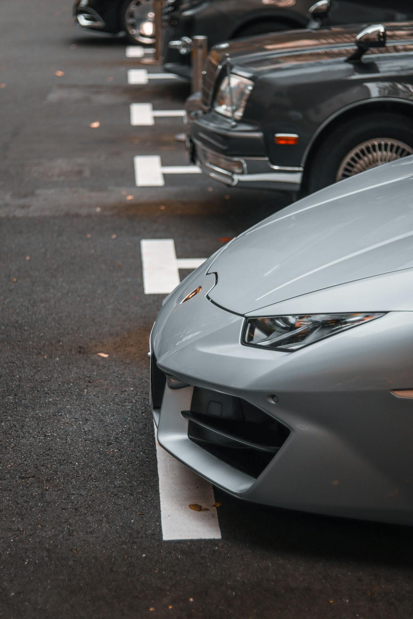 Close-up of a silver Lamborghini Huracan parked, emphasizing luxury and design.